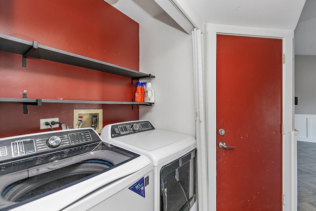 washroom featuring parquet flooring and washer and dryer