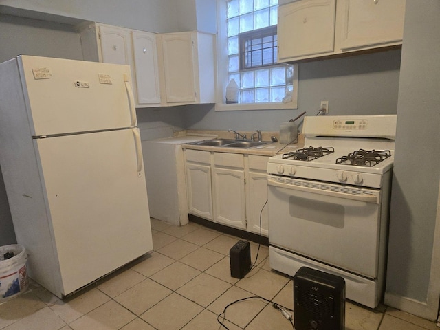 kitchen with light tile patterned flooring, sink, white cabinets, and white appliances