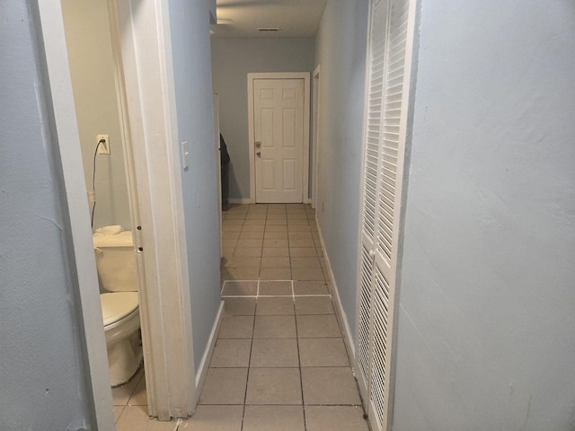 hall featuring light tile patterned floors