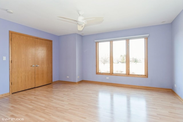 unfurnished bedroom with ceiling fan, a closet, and light hardwood / wood-style flooring