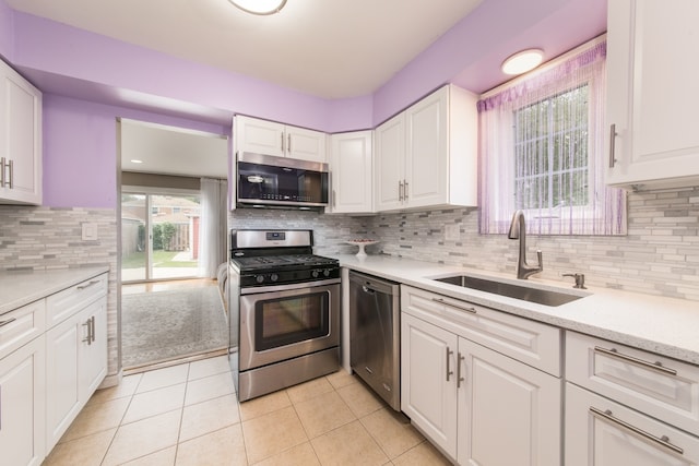 kitchen featuring sink, stainless steel appliances, and white cabinets