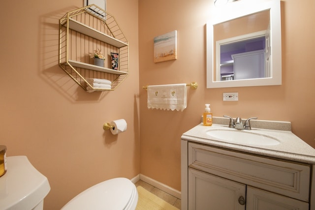 bathroom featuring toilet, tile patterned floors, and vanity