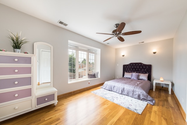 bedroom with ceiling fan and light hardwood / wood-style floors