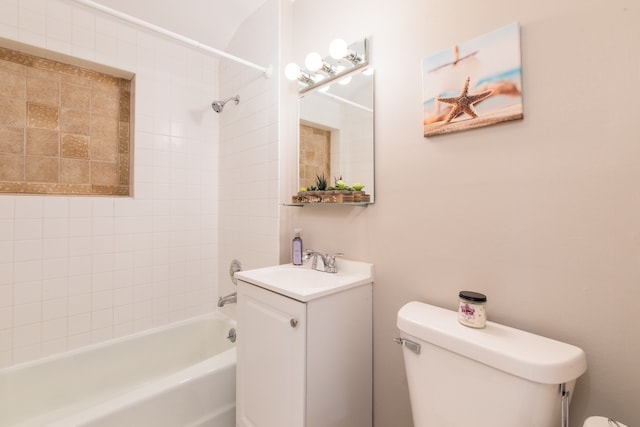 full bathroom with vanity, toilet, and tiled shower / bath