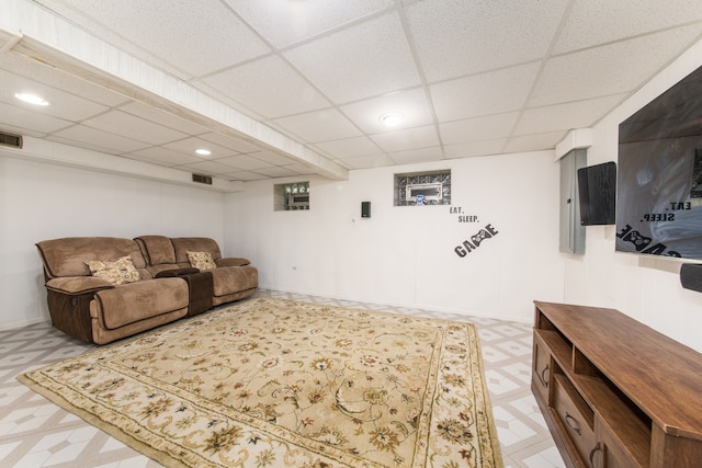 living room featuring a drop ceiling