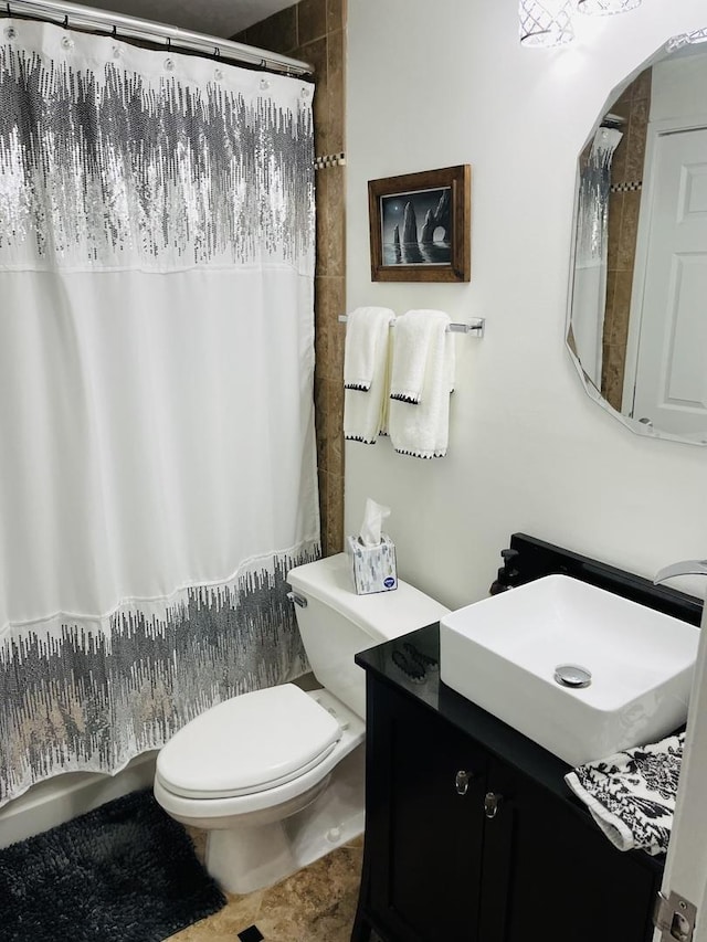 bathroom featuring toilet, curtained shower, and vanity