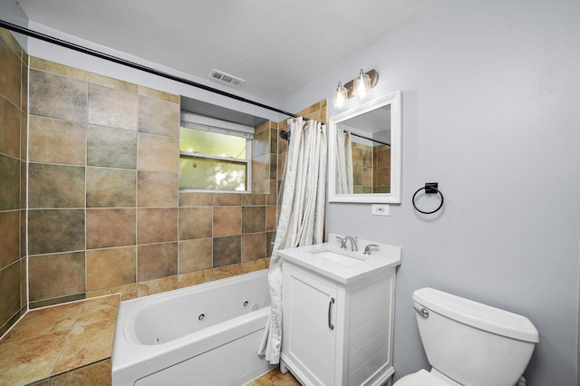 full bathroom with vanity, shower / tub combo, and toilet