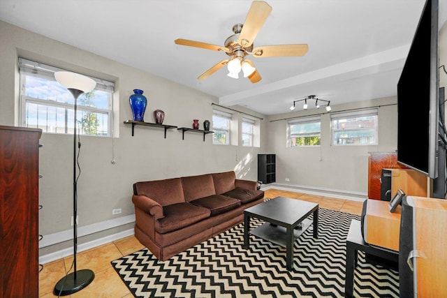 living room featuring light tile patterned flooring, ceiling fan, and a healthy amount of sunlight