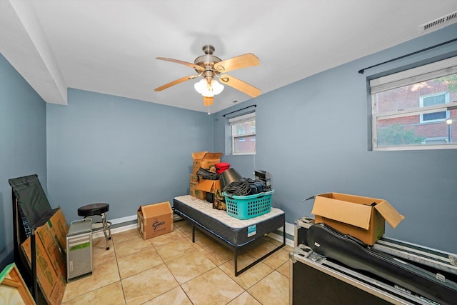 miscellaneous room with light tile patterned floors and ceiling fan