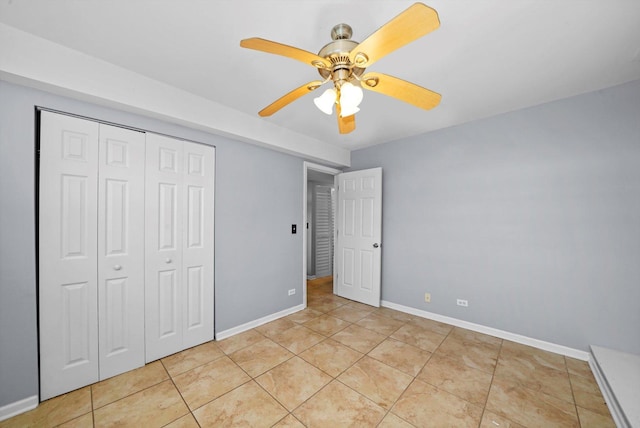 unfurnished bedroom with ceiling fan, a closet, and light tile patterned floors