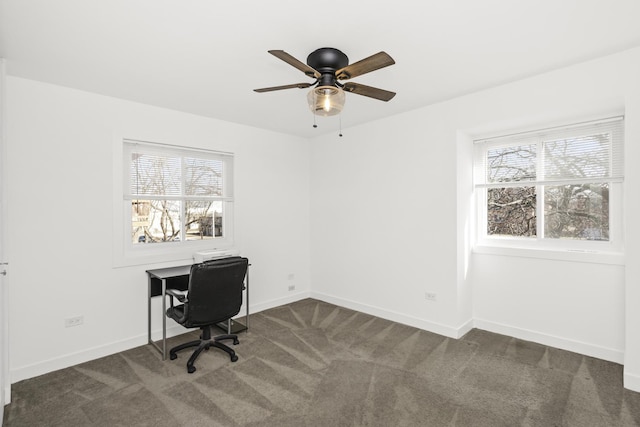 office space with ceiling fan and dark colored carpet