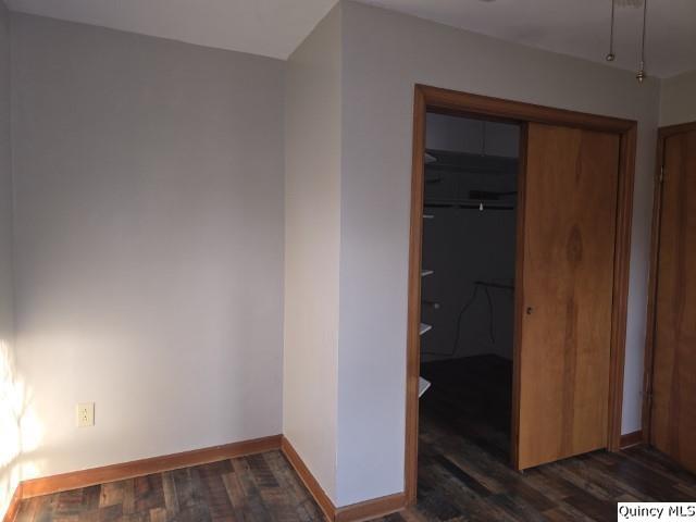 spare room with dark hardwood / wood-style flooring