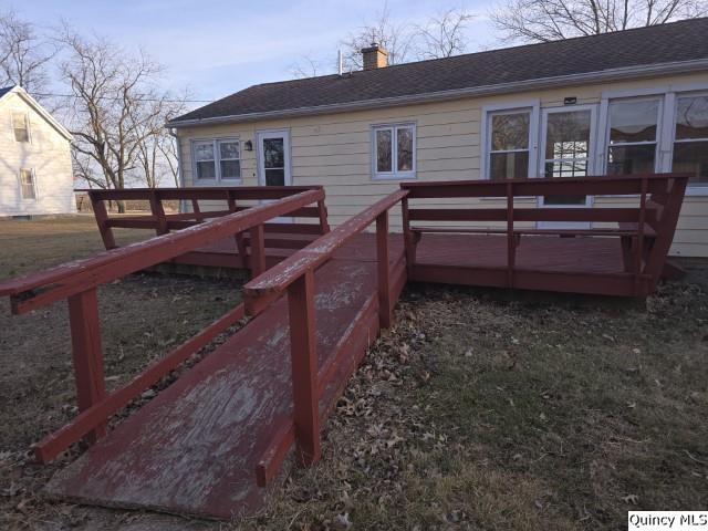 rear view of property featuring a deck