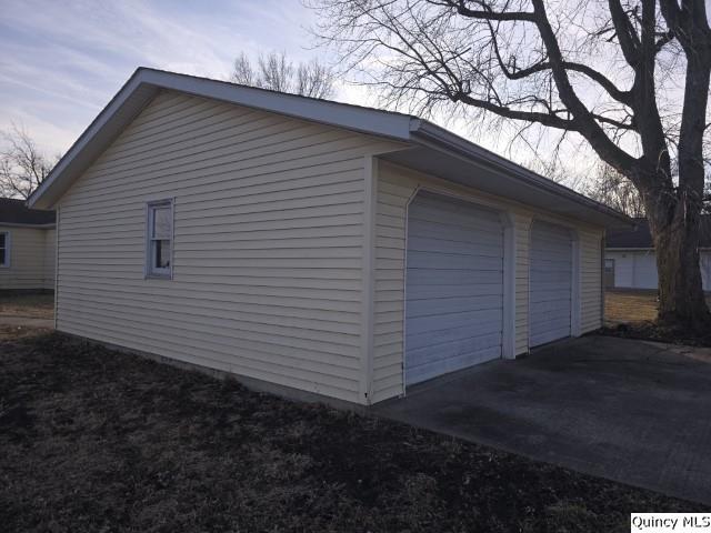 view of side of property with an outbuilding and a garage