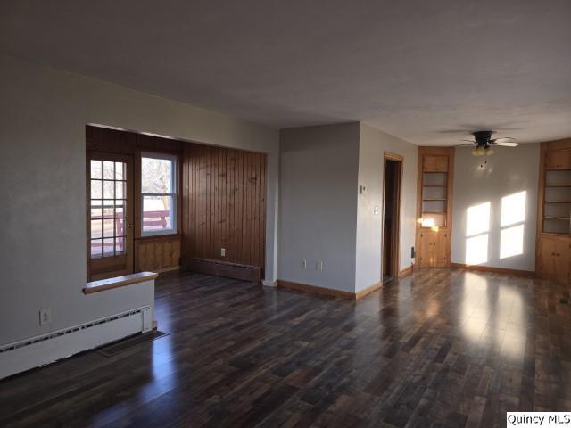 unfurnished room with a baseboard radiator, dark hardwood / wood-style floors, and ceiling fan