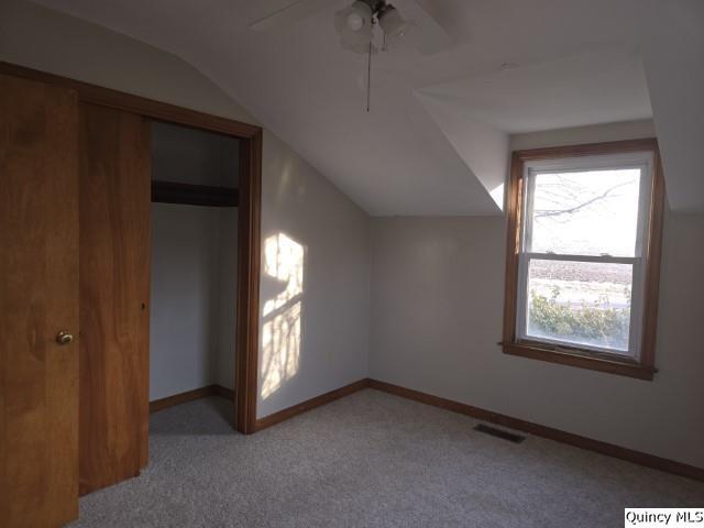 bonus room with ceiling fan, lofted ceiling, and light carpet