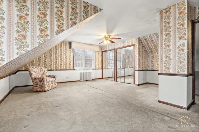 interior space featuring ceiling fan and radiator heating unit