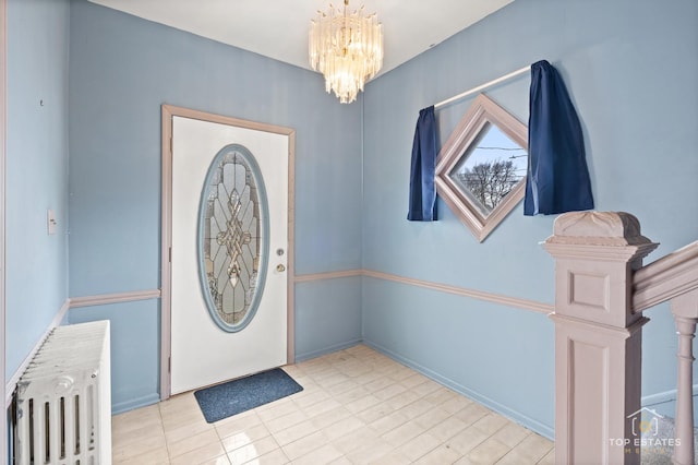 entryway featuring radiator heating unit and a chandelier