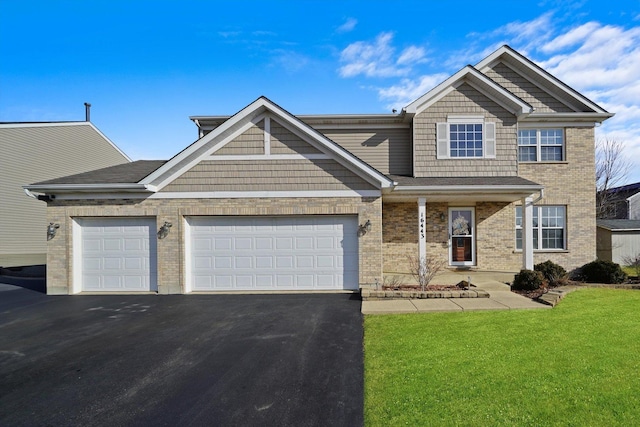 view of front of property with a garage and a front yard