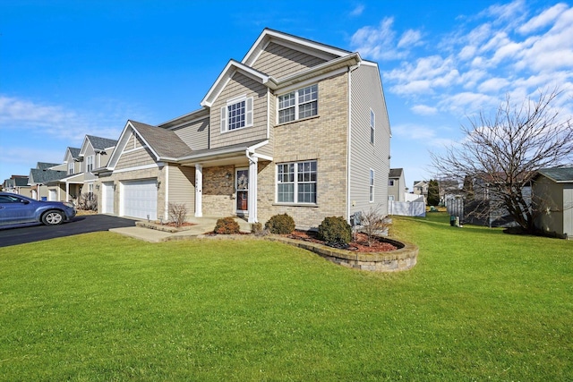 view of front of property with a garage and a front lawn