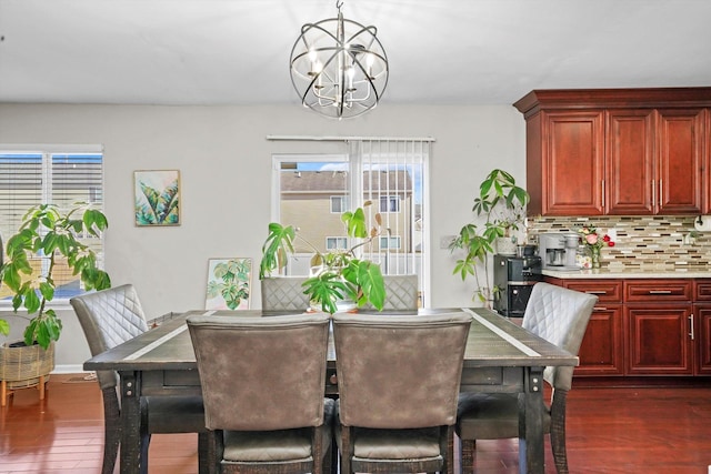 dining space featuring dark hardwood / wood-style floors and a notable chandelier