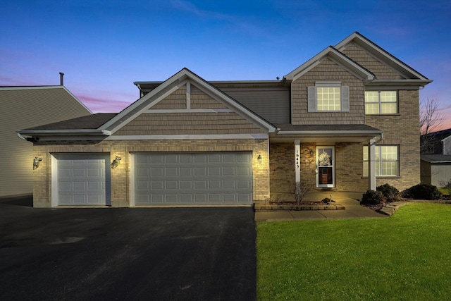 view of front of home featuring a garage and a lawn