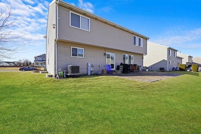 rear view of house with a patio, central air condition unit, and a lawn