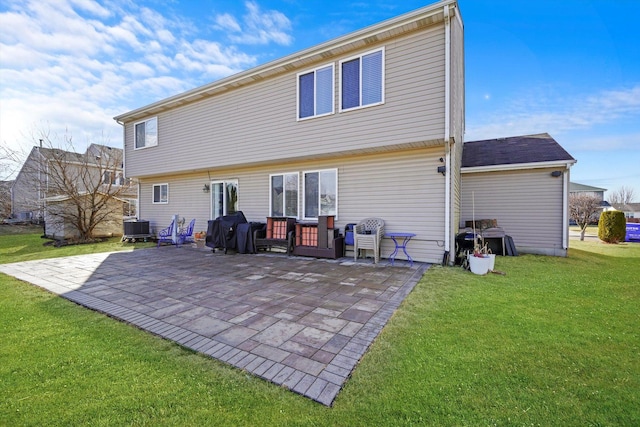 back of house with central AC unit, a yard, and a patio area