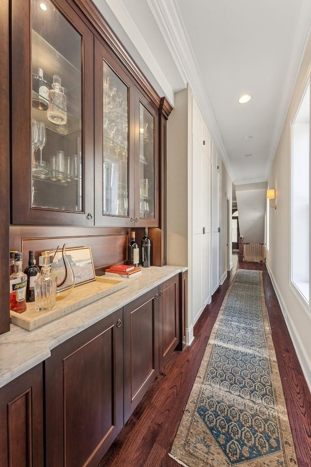 hallway with ornamental molding, radiator, and dark hardwood / wood-style flooring