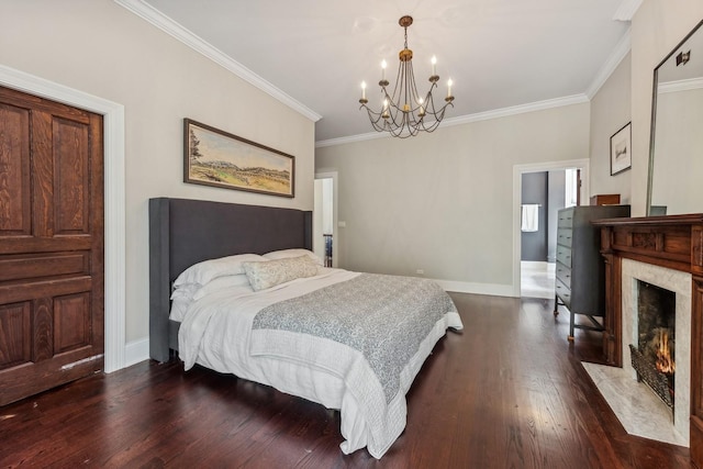 bedroom featuring crown molding, a notable chandelier, dark wood-type flooring, and a fireplace