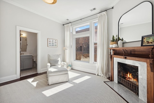 sitting room featuring crown molding and a premium fireplace