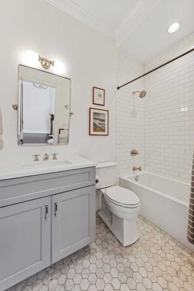 full bathroom with tiled shower / bath, ornamental molding, toilet, and vanity