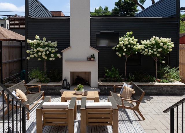 view of patio / terrace with an outdoor living space with a fireplace