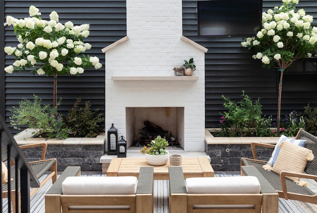 view of patio / terrace featuring an outdoor brick fireplace