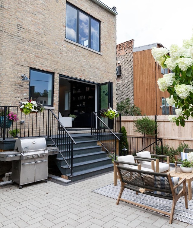 view of exterior entry featuring an outdoor hangout area and a patio