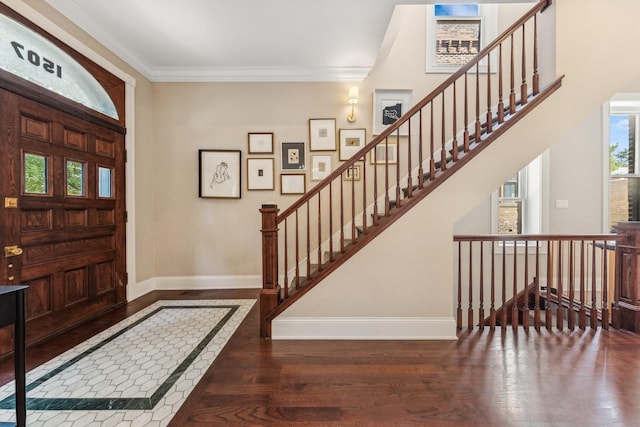 foyer entrance featuring crown molding and dark wood-type flooring