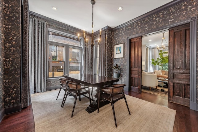 dining room featuring an inviting chandelier, hardwood / wood-style floors, and ornamental molding