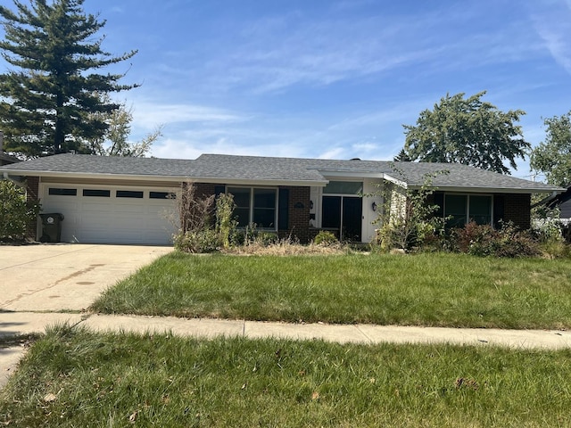 single story home featuring a garage and a front yard