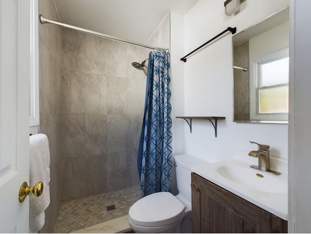 bathroom with a shower with curtain, vanity, and toilet