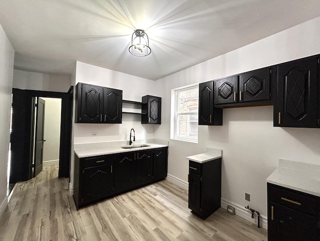 kitchen with sink and light hardwood / wood-style flooring