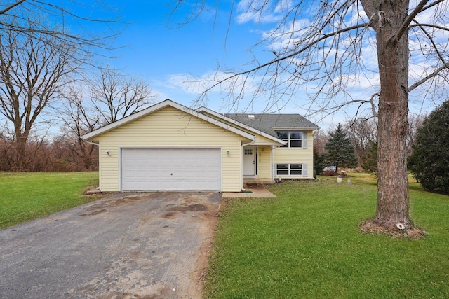 view of front of house with a garage and a front yard