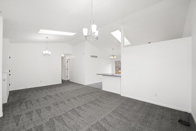 unfurnished living room with lofted ceiling with skylight, a chandelier, and dark carpet