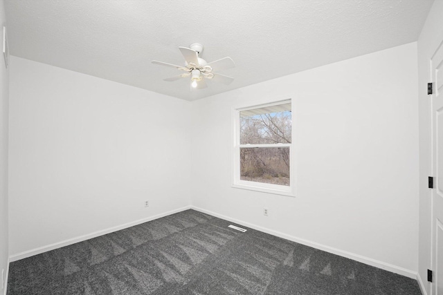 empty room featuring ceiling fan, carpet flooring, and a textured ceiling