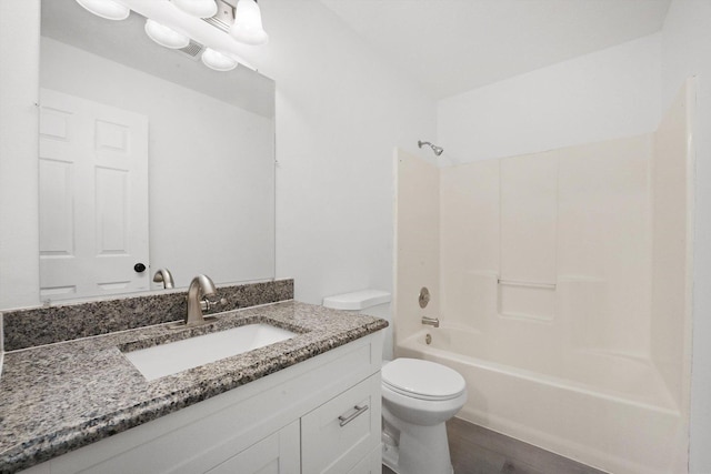 full bathroom with vanity, bathtub / shower combination, and toilet