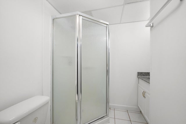 bathroom featuring vanity, an enclosed shower, tile patterned flooring, and toilet