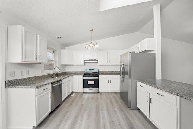 kitchen featuring appliances with stainless steel finishes, sink, dark stone counters, and white cabinets