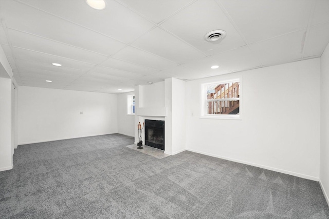 basement featuring carpet flooring and a drop ceiling