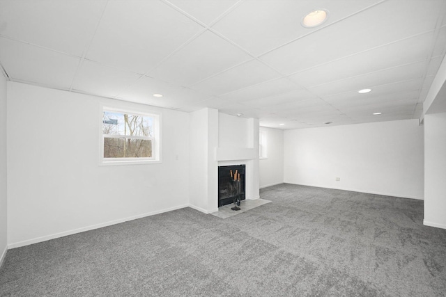 basement with carpet flooring and a paneled ceiling