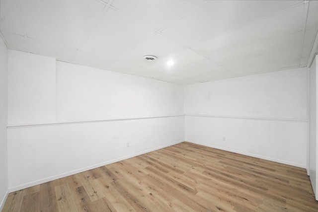 unfurnished room featuring a paneled ceiling and wood-type flooring