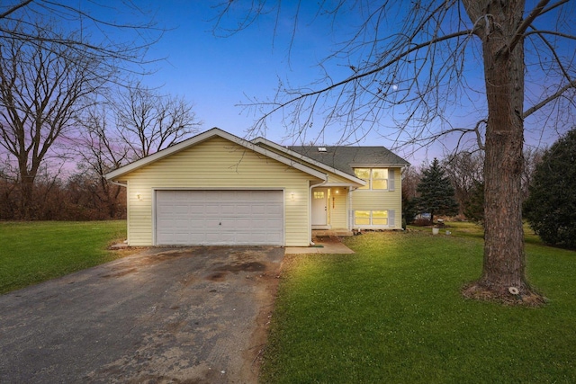 view of front facade with a garage and a lawn